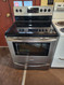 FRIGIDAIRE 30 INCH FREESTANDING SMOOTH 5 BURNER RANGE 1 LARGE DUAL 1 MEDIUM DUAL 2 SMALL WITH CENTER WARMING BURNER SELF CLEANING OVEN STAINLESS AND BLACK LOCATED IN OUR PORTLAND OREGON APPLIANCE STORE SKU 18472