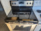 WHIRLPOOL 30 INCH FREESTANDING SMOOTH TOP ELECTRIC RANGE 4 BURNER 1 LARGE DUAL 1 LARGE 2 SMALL MANUAL CLEAN OVEN BLACK AND STAINLESS LOCATED IN OUR PORTLAND OREGON APPLIANCE SKU 19145