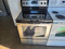 WHIRLPOOL 30 INCH FREESTANDING SMOOTH TOP ELECTRIC RANGE 4 BURNER 1 LARGE DUAL 1 LARGE 2 SMALL MANUAL CLEAN OVEN BLACK AND STAINLESS LOCATED IN OUR PORTLAND OREGON APPLIANCE SKU 19145