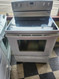 AMANA 30 INCH FREESTANDING GLASS TOP ELECTRIC RANGE  4 BURNERS 2 LARGE 2 SMALL KEEP WARM OPTION SELF CLEANING OVEN WHITE LOCATED IN OUR PORTLAND OREGON APPLIANCE STORE SKU 19152