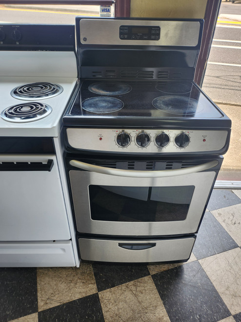 GE 24 INCH FREESTANDING ELECTRIC RANGE SMOOTH TOP WITH 4 BURNERS HI LO BROIL SETTING SELF CLEANING OVEN BLACK AND STAINLESS LOCATED IN OUR PORTLAND OREGON APPLIANCE STORE SKU 19249