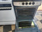 GE 24 INCH FREESTANDING ELECTRIC RANGE SMOOTH TOP WITH 4 BURNERS HI LO BROIL SETTING SELF CLEANING OVEN BLACK AND STAINLESS LOCATED IN OUR PORTLAND OREGON APPLIANCE STORE SKU 19249