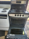 GE 24 INCH FREESTANDING ELECTRIC RANGE SMOOTH TOP WITH 4 BURNERS HI LO BROIL SETTING SELF CLEANING OVEN BLACK AND STAINLESS LOCATED IN OUR PORTLAND OREGON APPLIANCE STORE SKU 19249