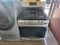 FRIGIDAIRE 30 INCH STANDING 5 BURNER PROPANE GAS RANGE STEAM AND SELF CLEANING OVEN QUICK BAKE SETTING STAINLESS AND BLACK LOCATED IN OUR PORTLAND OREGON APPLIANCE STORE SKU 19455