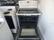 GE FREESTANDING SMOOTH TOP ELECTRIC RANGE 4 BURNER 1 LARGE DUAL 1 LARGE 2 SMALL HI LO BROIL OPTION SELF CLEANING WHITE LOCATED IN OUR PORTLAND OREGON APPLIANCE STORE SKU 19514