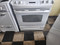GE 30 INCH SLIDE-IN GLASS TOP ELECRTIC RANGE 5 BURNER 1 BRIDGE 1 LARGE DUAL CENTER WARMING BURNER 2 SMALL HI-LO BROIL SETTING SELF CLEANING OVEN WHITE LOCATED IN OUR PORTLAND OREGON STORE SKU 19662