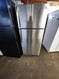 GE 16 CUBIC FOOT REFRIGERATOR TOP FREEZER FULL WIDTH GLASS SHELVES 2 CRISPER DRAWERS WIRE SHELF IN FREEZER STAINLESS LOCATED IN OUR PORTLAND OREGON APPLIANCE STORE SKU 19878