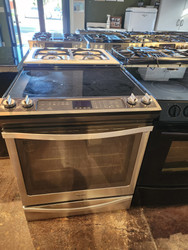 WHIRLPOOL 30 INCH SLIDE-IN SMOOTH TOP ELECTRIC RANGE 5 BURNER CENTER BURNER IS A WARMING BURMER CONVECTION WITH AQUA LIFT SELFCLEAN COSMETIC ISSUES ON OVEN LINER DISCOLORED STAINLESS AND BLACK LOCATED IN OUR PORTLAND OREGON APPLIANCE STORE SKU 19901