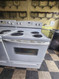 ESTATE BY WHIRLPOOL 30 INCH FREESTANDING ELECTRIC RANGE COIL BURNERS 2 LARGE 2 SMALL SELF CLEANING OVEN COSMETIC ISSUE TOP OF OVEN DOOR SEE PICS LOCATED IN OUR PORTLAND OREGON APPLIANCE STORE SKU 23067