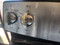 GE 30 INCH FREESTANDING 5 BURNER GLASS TOP RANGE 2 DUAL 2 SMALL 1 WARMING HI-LO BROIL OPTION SELF CLEANING OVEN STAINLESS AND BLACK LOCATED IN OUR PORTLAND OREGON APPLIANCE STORE SKU 23121