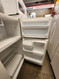 HOTPOINT 14 CUBIC FOOT REFRIGERATOR WIRE SHELVES 2 CRISPER DRAWERS COSMETIC ISSUES ON DOOR FEW DINGS ALMOND LOCATED IN OUR PORTLAND OREGON APPLIANCE STORE SKU 23154