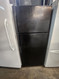 GE 17 CUBIC FOOT REFRIGERATOR TOP FREEZER ADJUSTABLE WIRE SHELVES 2 CRISPER DRAWERS FULL WIDTH SHELF IN FREEZER BLACK LOCATED IN OUR PORTLAND OREGON APPLIANCE STORE SKU 23242