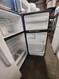 GE 17 CUBIC FOOT REFRIGERATOR TOP FREEZER ADJUSTABLE WIRE SHELVES 2 CRISPER DRAWERS FULL WIDTH SHELF IN FREEZER BLACK LOCATED IN OUR PORTLAND OREGON APPLIANCE STORE SKU 23242