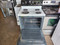 ESTATE 30 INCH FREESTANDING ELECTRIC RANGE MANUAL CLEAN COIL BURNERS 3 SMALL 1 LARGE WHITE WITH BLACK HANDLE AND PANEL LOCATED IN OUR PORTLAND OREGON APPLIANCE STORE SKU 23304