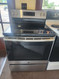 GE 30 Inch Freestanding Electric Range with 4 Element Burners, 5.3 Cu. Ft. Oven Capacity, Removable Storage Drawer, Self-Clean, Ceramic Glass Cooktop, Dual-Element Bake, Power Boil Elements Stainless SKU 23334