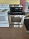 GE 30 INCH GLASS TOP FREESTANDING ELECTRIC RANGE 4 BURNERS 1 LARGE DUAL 1 LARGE 2 SMALL HI LO BROIL SETTING SELF CLEANING OVEN STORAGE DRAWER STAINLESS LOCATED IN OUR PORTLAND OREGON APPLIANCE STORE SKU 23338