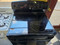 GE 30 INCH FREESTANDING 5 BURNER GLASS TOP RANGE 1 EXTRA LARGE DUAL 1 LARGE DUAL 2 SMALL CENTER WARNING BURNER HI/LO BROIL OPTION SELF CLEANING OVEN BLACK LOCATED IN OUR PORTLAND OREGON APPLIANCE STORE SKU 23341
