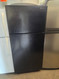AMERICANA BY GE 16 CUBIC FOOT REFRIGERATOR TOP FREEZER WIRE SHELVES 1 LARGE CRISPER DRAWER FULL WIDTH WIRE SHELF IN FREEZER BLACK LOCATED IN OUR PORTLAND OREGON SKU 23358