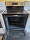 GE 30 INCH FREESTANDING SMOOTH TOP 4 BURNER ELECTRIC RANGE 2 LARGE DUAL BURNERS HI LO BROIL OPTION SELF CLEANING OVEN BLACK STAINLESS LOCATED IN OUR POTLAND OREGON APPLIANCE STORE SKU 23370