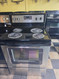 WHIRLPOOL 30 INCH FREESTANDING ELECTRIC RANGE COIL BURNERS 2 LARGE 2 SMALL KEEP WARM OPTION SELF CLEANING OVEN BLACK AND STAINLESS LOCATED IN OUR PORTLAND OREGON APPLIANCE STORE SKU 23381