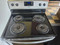 ESTATE BY WHIRLPOOL 30 INCH FREESTANDING ELECTRIC RANGE 4 COIL BURNERS 2 LARGE 2 SMALL SELF CLEANING OVEN COSMETIC ISSUES ON CONTROL PANEL SILVER AND BLACK LOCATED IN OUR PORTLAND OREGON APPLIANCE STORE SKU 23385