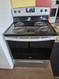 ESTATE BY WHIRLPOOL 30 INCH FREESTANDING ELECTRIC RANGE 4 COIL BURNERS 2 LARGE 2 SMALL SELF CLEANING OVEN COSMETIC ISSUES ON CONTROL PANEL SILVER AND BLACK LOCATED IN OUR PORTLAND OREGON APPLIANCE STORE SKU 23385