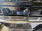 GE 30 INCH FREESTANDING GAS RANGE 4 BURNER MANUAL CLEAN OVEN BOTTOM BROILER BLACK AND STAINLESS LOCATED IN OUR PORTLAND OREGON APPLIANCE STORE SKU 23812