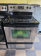 WHIRLPOOL 30 INCH FREESTANDING GLASS TOP ELECTRIC RANGE 4 BURNER 2 LARGE DUAL 2 SMALL SELF CLEANING OVEN STORAGE DRAWER BLACK AND STAINLESS LOCATED IN OUR PORTLAND OREGON APPLIANCE STORE SKU 24023