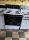 HOTPOINT 30 INCH FREESTANDING ELECTRIC RANGE COIL BURNERS 2 LARGE 2 SMALL SELF CLEANING OVEN HI LO BROIL OPTION WHITE WITH BLACK GLASS DOOR NO WINDOW LOCATED IN OUR PORTLAND OREGON APPLIANCE STORE SKU 24090