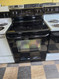 FRIGIDAIRE 30 INCH FREESTANDING GLASS RANGE 4 BURNERS 1 LARGE DUAL 1 LARGE 2 SMALL SELF CLEANING OVEN BLACK LOCATED IN OUR PORTLAND OREGON APPLIANCE STORE SKU 24094