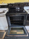 FRIGIDAIRE 30 INCH FREESTANDING GLASS RANGE 4 BURNERS 1 LARGE DUAL 1 LARGE 2 SMALL SELF CLEANING OVEN BLACK LOCATED IN OUR PORTLAND OREGON APPLIANCE STORE SKU 24094