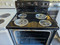 Amana 30 Inch Freestanding Electric Range with 4 Coil Elements, 4.8 Cu. Ft. Oven Capacity, Storage Drawer, Self-Cleaning, Temp Assure™ Cooking System, Indicator Lights, Sabbath Mode, Touch Electronic Controls Plus Black SKU 24157