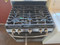 GE 30 Inch Freestanding PROPANE Gas Range with 5 Sealed Burners, 5 Cu. Ft. Oven Capacity, Storage Drawer, Continuous Grates, Self-Clean, Control Lock Capability, Center Oval Burner, and Precise Simmer Burner: Stainless Steel SKU 24198
