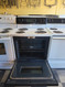 KENMORE 30 INCH FREESTANDING ELECTRIC RANGE SELF CLEANING OVEN COIL BURNERS 2 SMALL 2 LARGE STORAGE DRAWER WHITE WITH BLACK GLASS OVEN DOOR LOCATED IN OUR PORTLAND OREGON APPLIANCE STORE SKU 24221