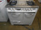 VINTAGE 36 INCH WEDGEWOOD GAS RANGE WITH 4 BURNERS AND CENTER GRIDDLE SIDE HEATER OVEN ON LEFT SIDE AND BOTTOM BROILER WHITE WITH CHROME TOP AND HANDLES WHITE KNOBS LOCATED IN OUR PORTLAND OREGON APPLIANCE STORE