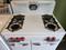 VINTAGE O'KEEFE & MERRITT 35 INCH 4 BURNER GAS FREE STANDING GAS RANGE SINGLE OVEN WITH BROILER DRAWER ON BOTTOM SIDE STORAGE COMPARTMENT WHITE WITH RED KNOBS AND CHROME HANDLES LOCATED IN OUR PORTLAND OREGON APPLIANCE STORE SKU 17206