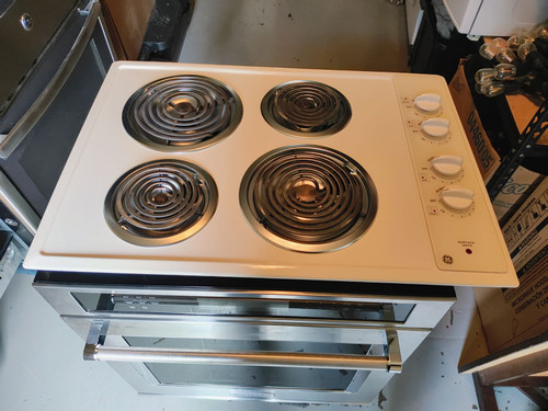 GE 30 INCH ELECTRIC COOK TOP 4 COIL BURNERS 2 LARGE 2 SMALL BISQUE LOCATED IN OUR PORTLAND OREGON APPLIANCE STORE SKU 17586