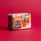 HOLIDAY TIN 5 OZ MATTE ILLUSTRATED TIN WITH STOREFRONT SCENE - SWEET ORANGE & FIR, CT0504