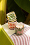 A DOPO 8 OZ HANDPAINTED "JUNGLE" CERAMIC CANDLE - COCONUT & AMBER, AD0809