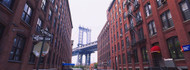 View of Manhattan Bridge Through Buildings