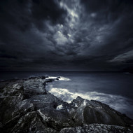Black Rocks Protruding Through Rough Seas With Stormy Clouds Crete Greece