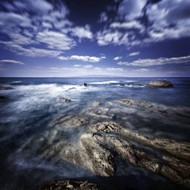 Rocky Shore With Tranquil Sea Against Cloudy Sky At Sunset Sardinia Italy