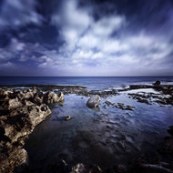 Rocky Shore With Tranquil Sea And Cloudy Sky At Sunset Sardinia Italy