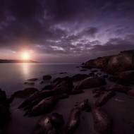 Rocky Shore And Tranquil Sea Against Cloudy Sky At Sunset Sardinia Italy