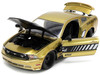 2010 Ford Mustang GT Gold Metallic with Black Graphics and Hood Tom s Racing Bigtime Muscle Series 1/24 Diecast Model Car Jada 33055