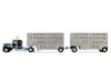 Peterbilt 389 with 36" Flat Top Sleeper and 28' Wilson Silverstar Double Livestock Trailers Black with Cyan Stripes 1/64 Diecast Model First Gear 60-2341