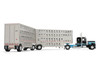 Peterbilt 389 with 36" Flat Top Sleeper and 28' Wilson Silverstar Double Livestock Trailers Black with Cyan Stripes 1/64 Diecast Model First Gear 60-2341