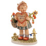 The 13-inch M.I. Hummel 'Valentine Gift' Masterpiece (HUM 387/III) features a girl with baskets of flowers and a songbird. Close-up of the intricately sculpted flowers and the soft, authentic painting style of the Masterpiece Valentine Gift.