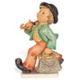 M.I. Hummel Masterpiece Collection figurine HUM 7/III Merry Wanderer featuring a young boy traveler with a red umbrella and carpetbag, handcrafted in Germany.