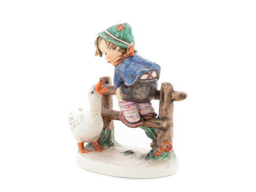 M.I. Hummel 'Barnyard Hero' figurine (HUM 195) featuring a boy sitting on a fence while a white goose honks at him.